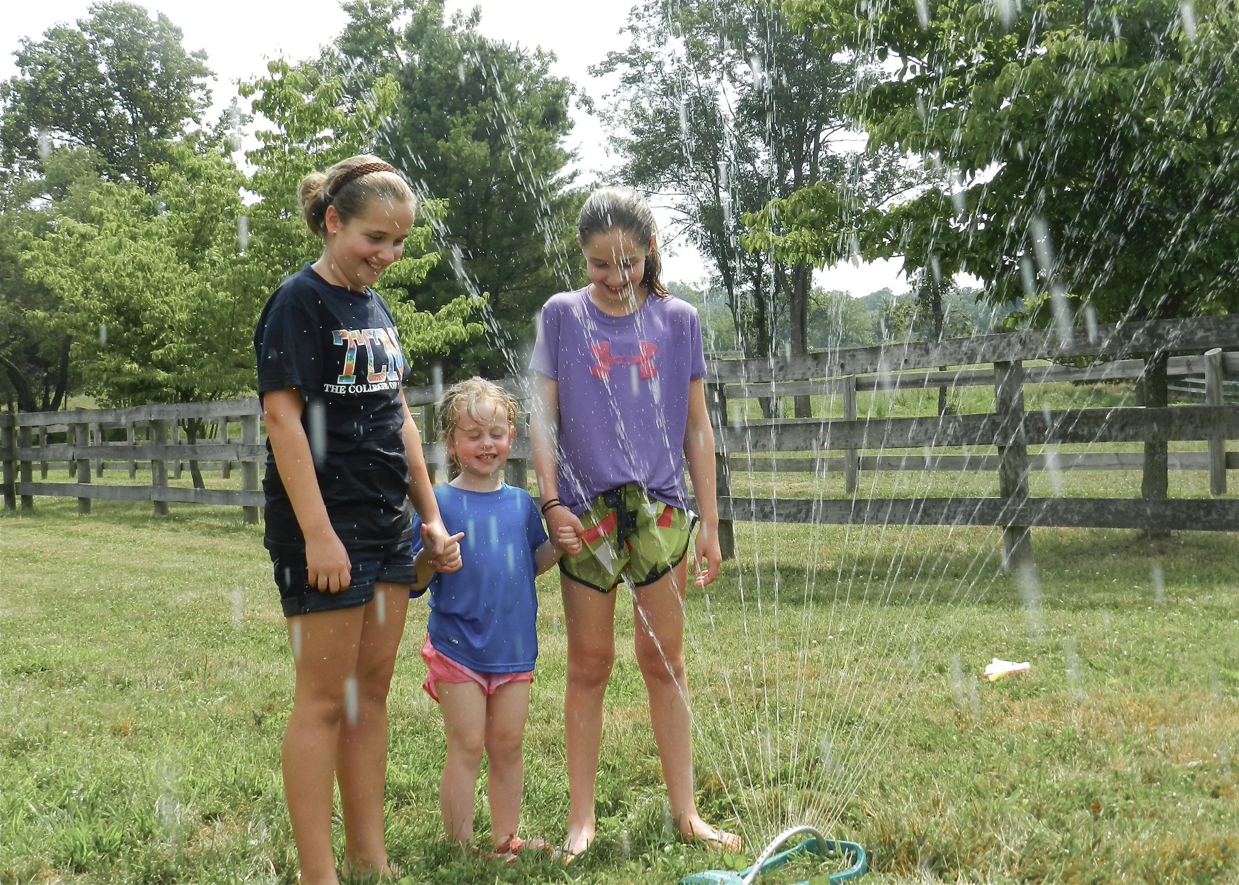 3 girls in sprinkler.jpg