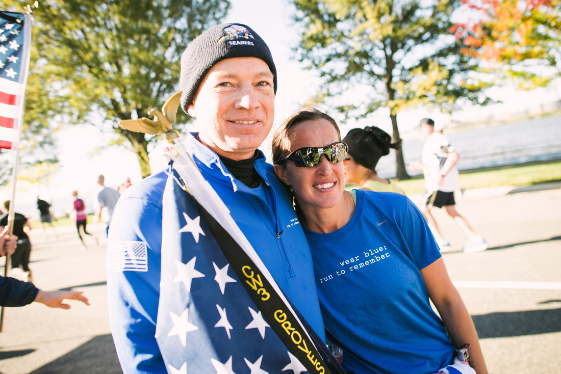 Phillip Cyr and Katie Groves share a moment on the wear blue Mile at the 2014 Marine Corps Marathon. Photo courtesy Ingrid Barrentine of Grit City Photography.