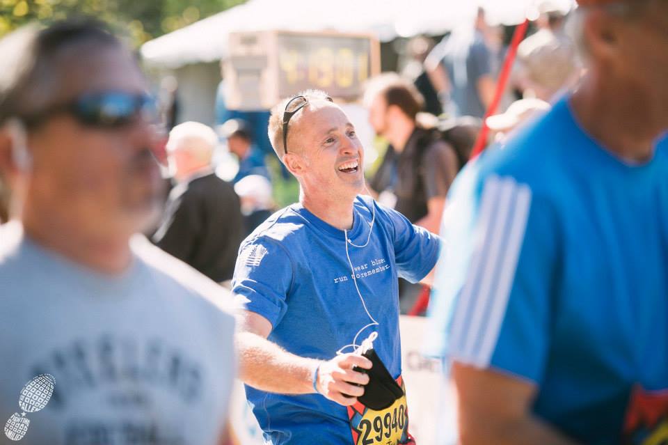 Brian Nelson crossing the finish line at the 2014 Marine Corps Marathon. Photo courtesy of Ingrid Barrentine of Grit City Photography.