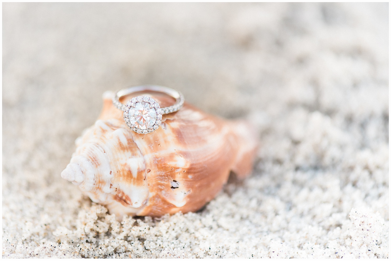 engagement ring in the sand