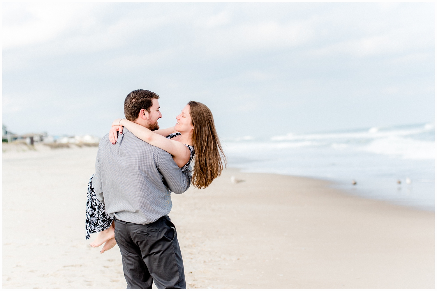 man carrying woman on the beach