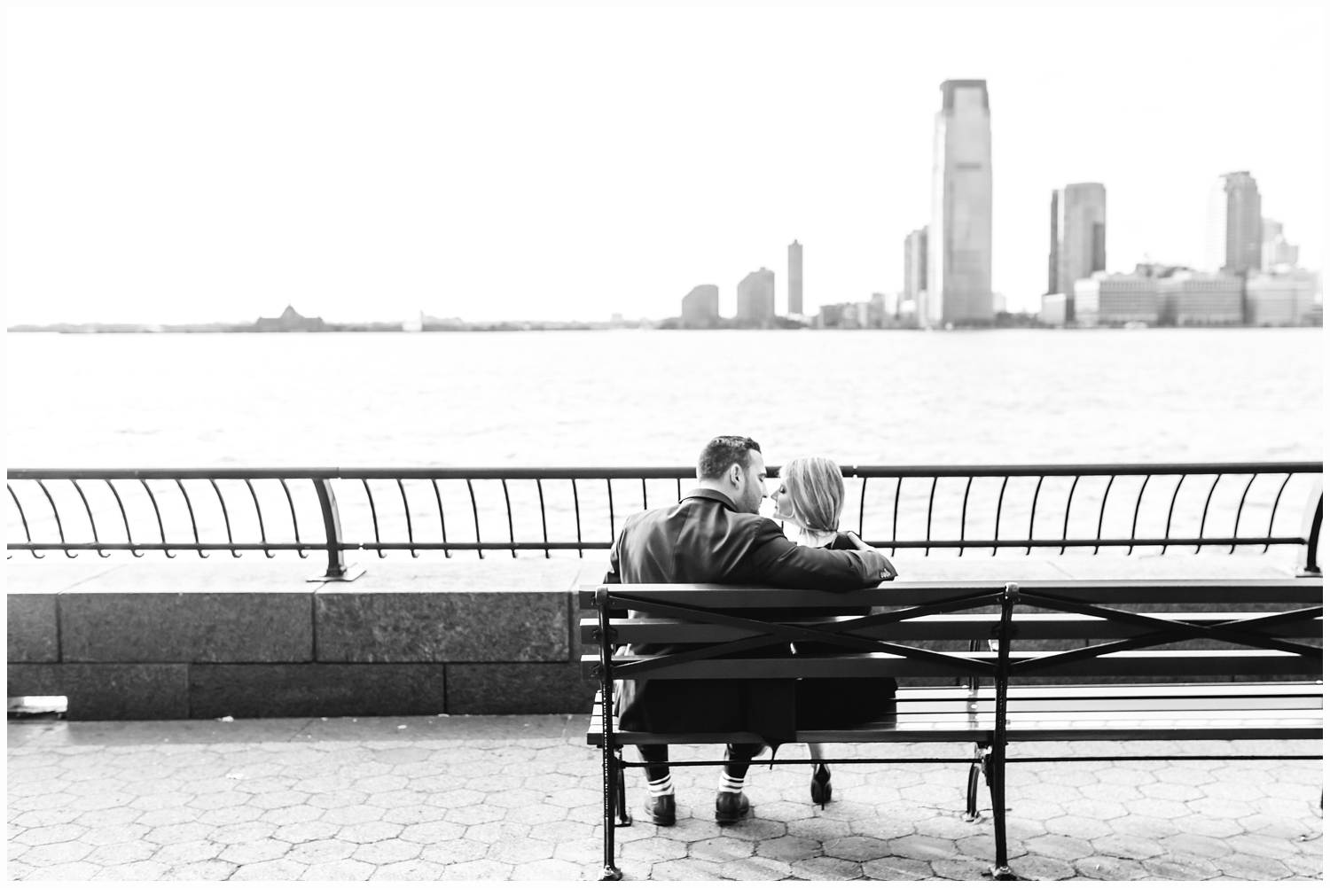 engaged couple by battery park city waterfront