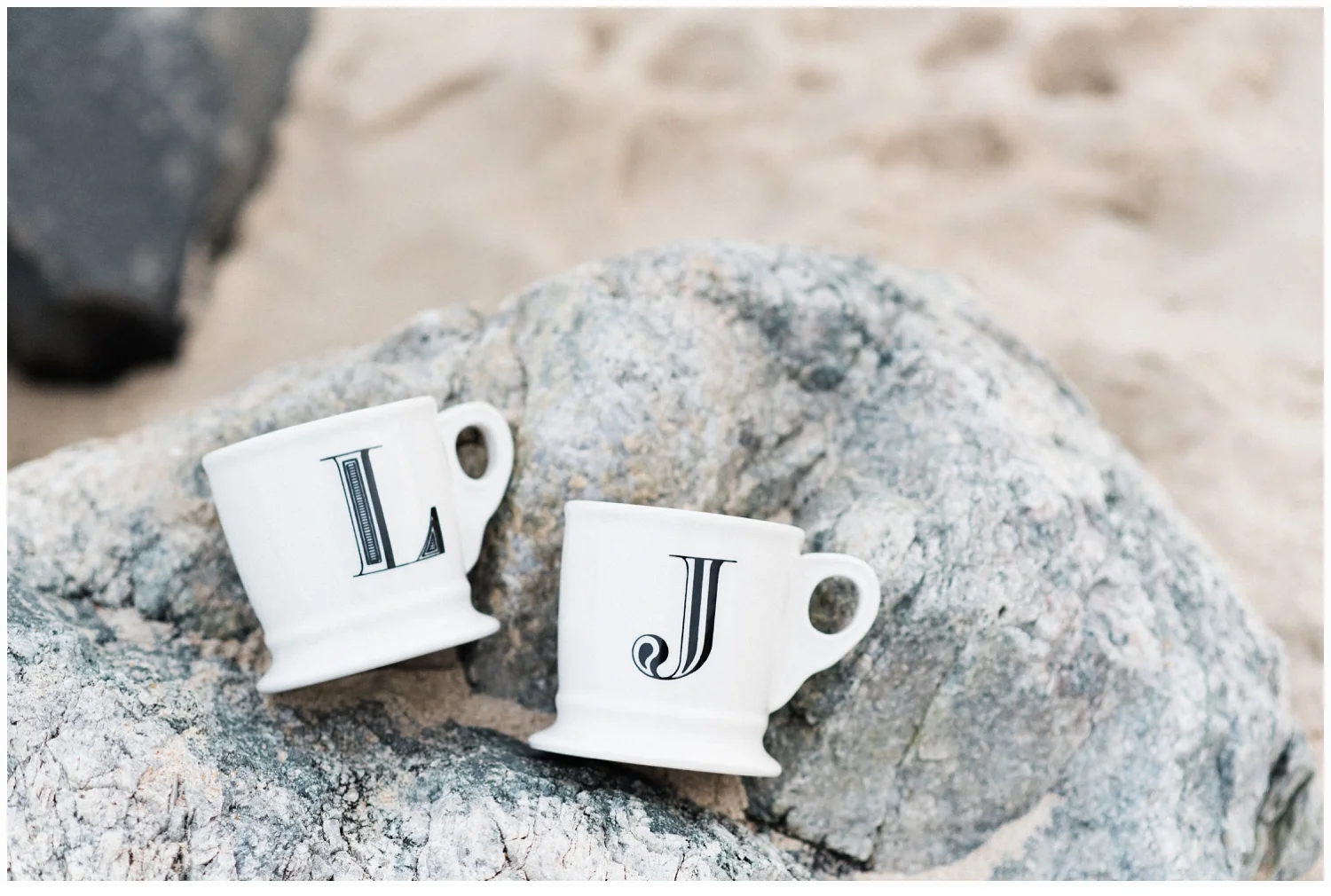 coffee mugs on rocks on beach