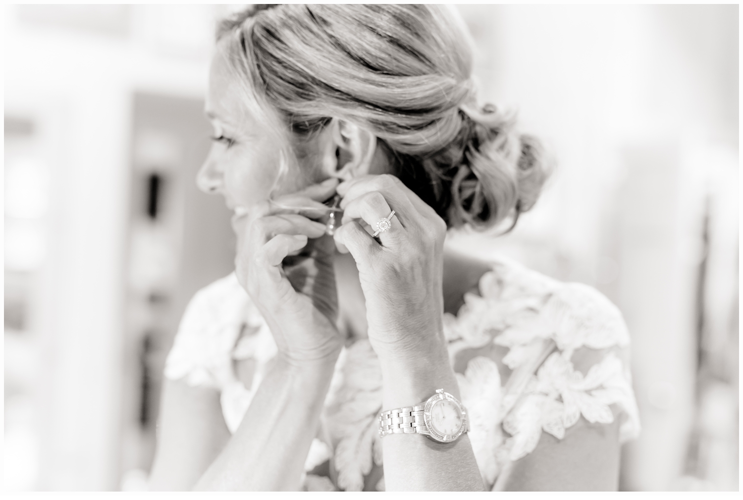 bride putting on earrings