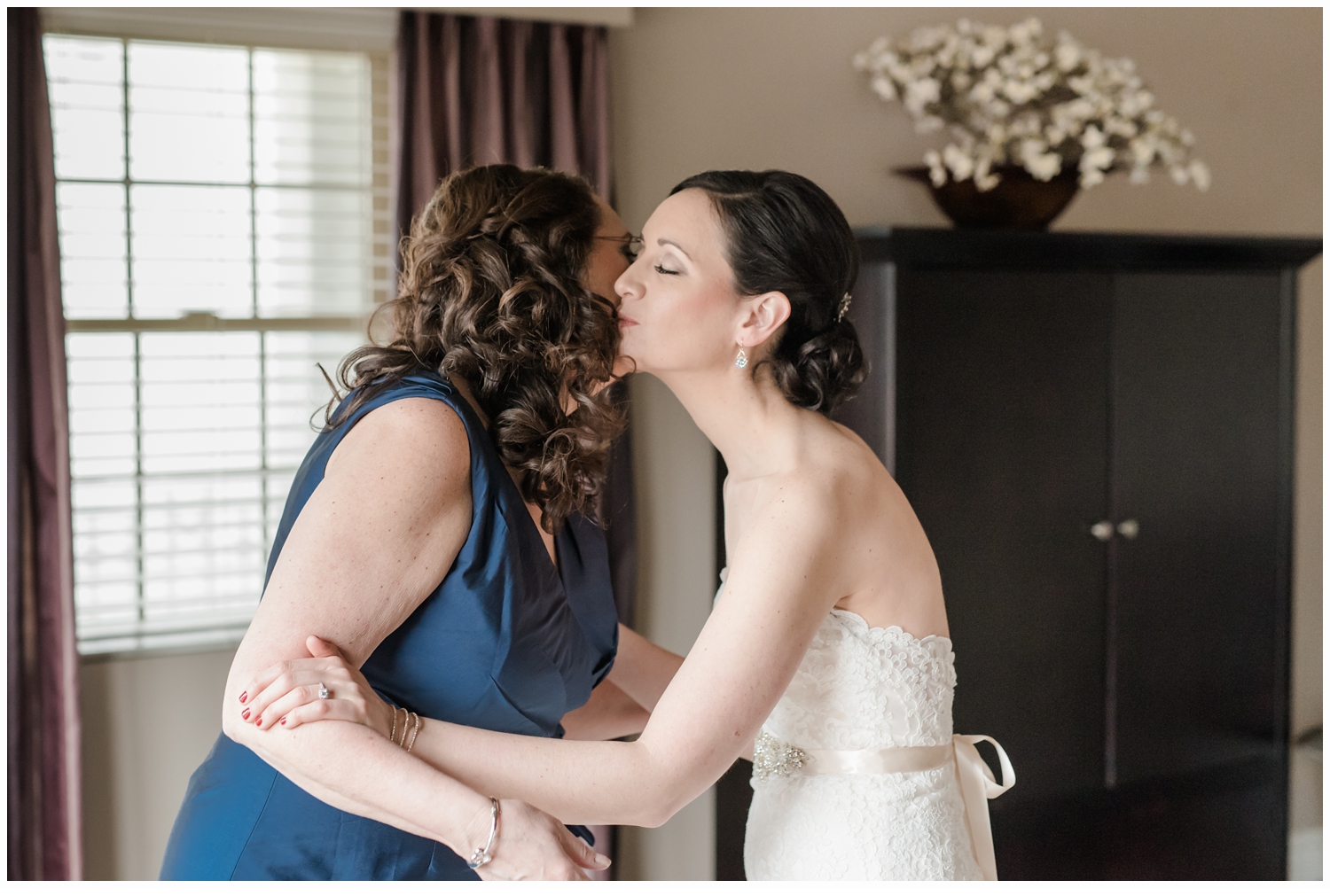 wedding day mother and daughter kiss