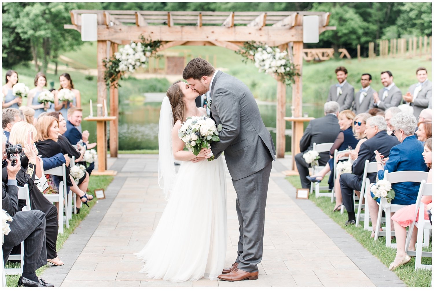 bride and groom kissing at wedding ceremony