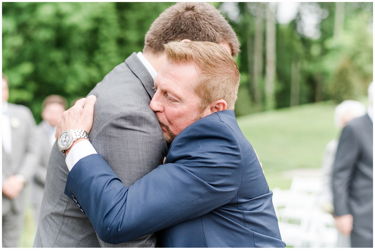 groom hugging father of the bride