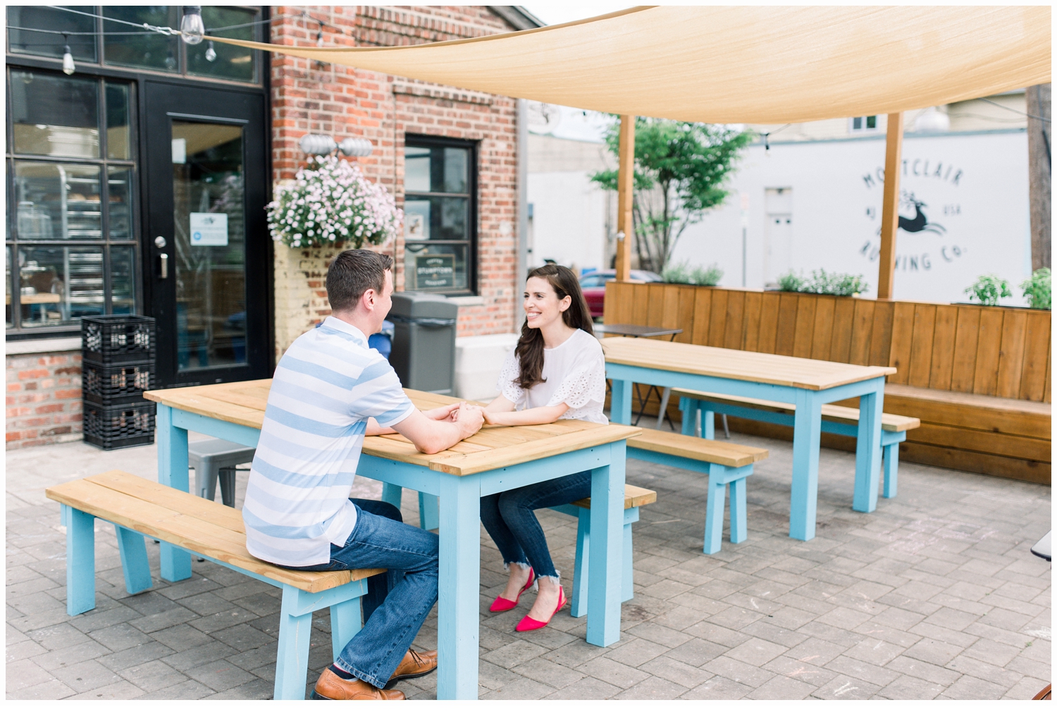 couple holding hands at a bakery