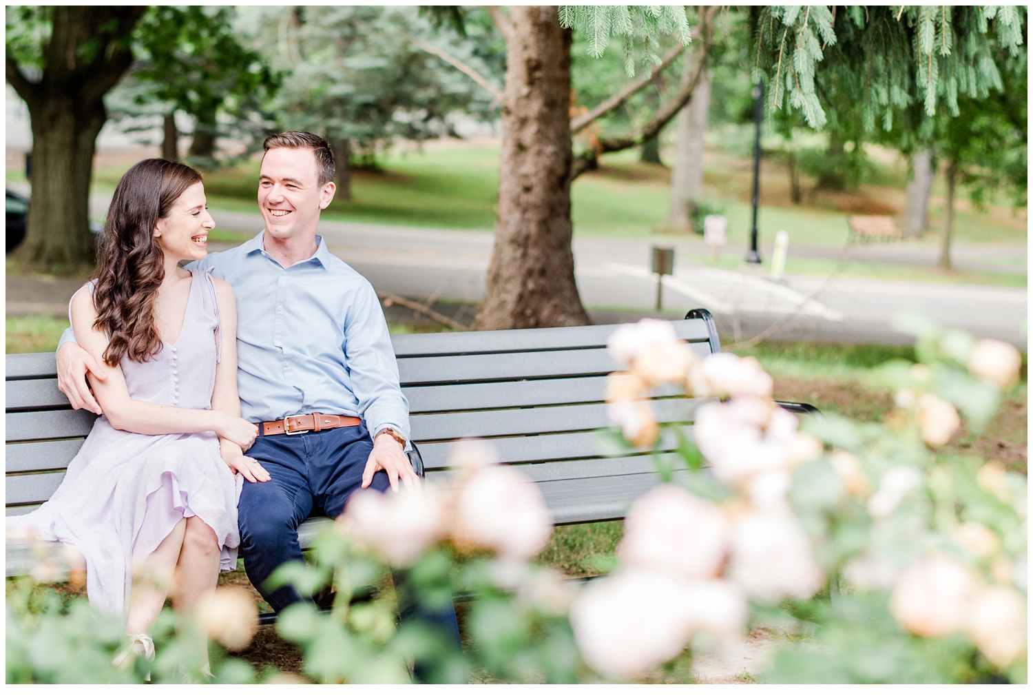 couple laughing on park bench