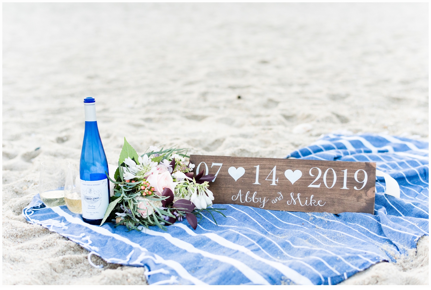 bottle of wine on a beach blanket