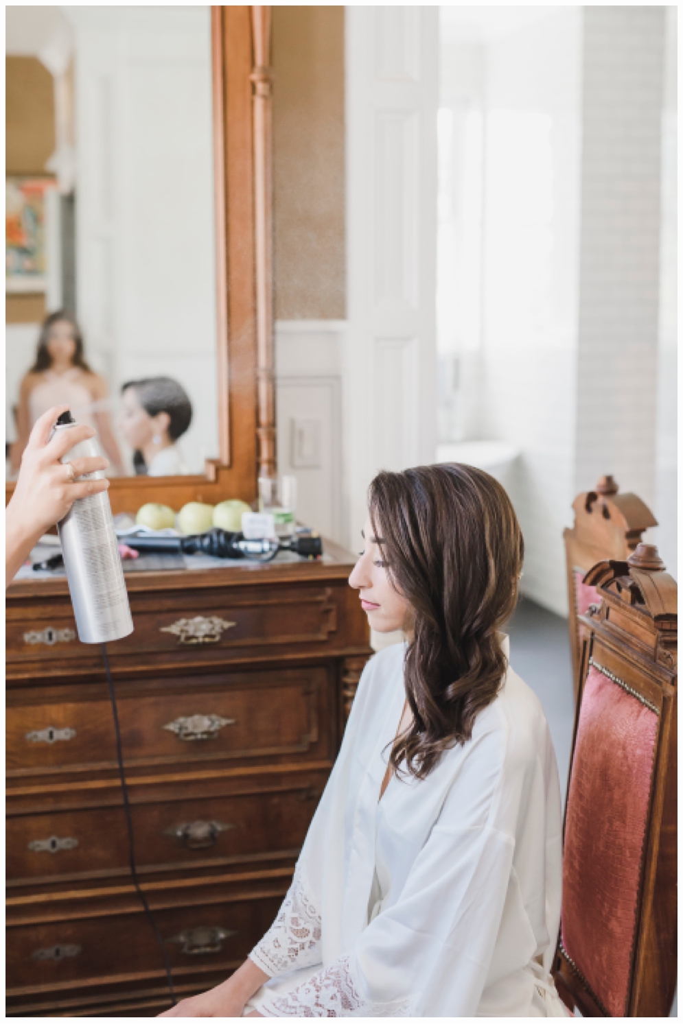 bride getting hair and makeup done