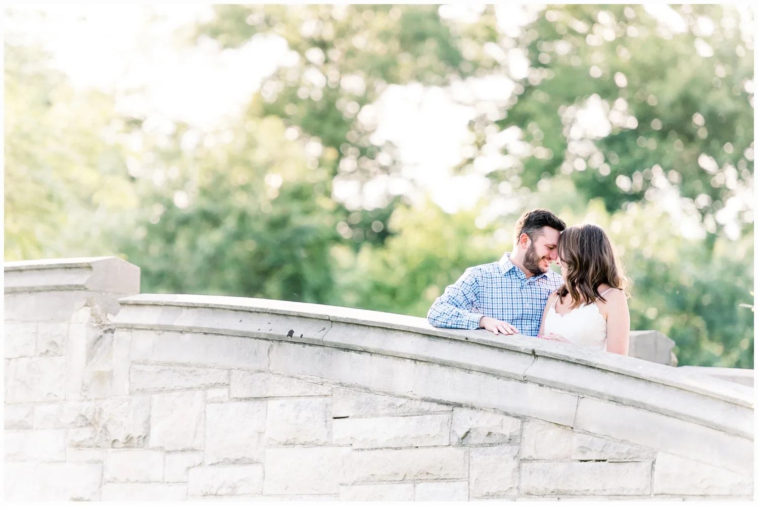 engaged couple on bridge