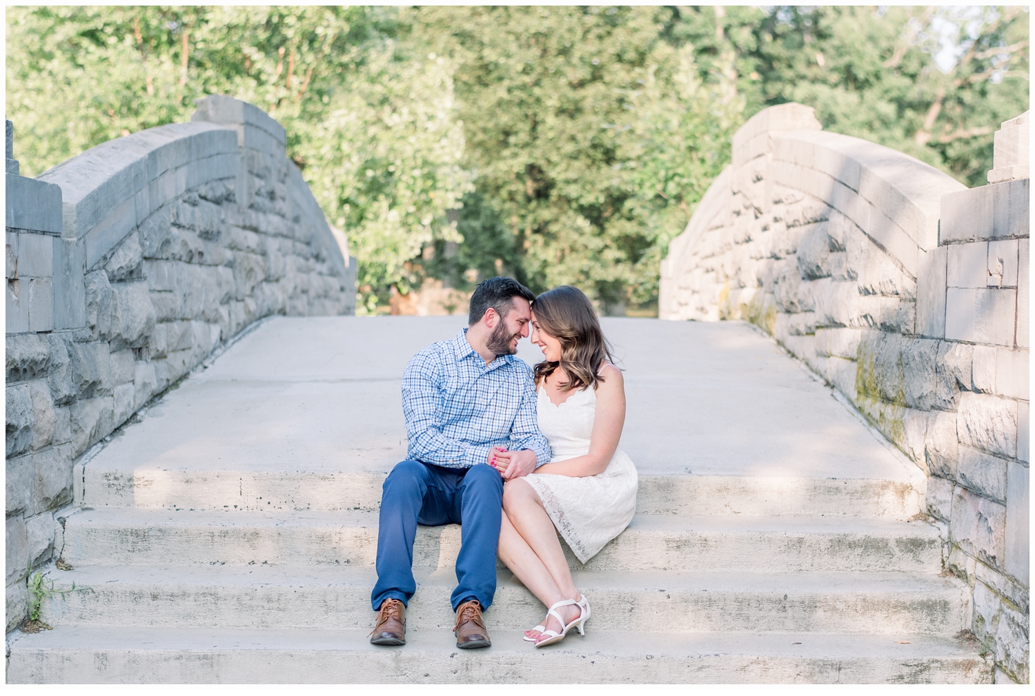 engaged couple hugging on steps