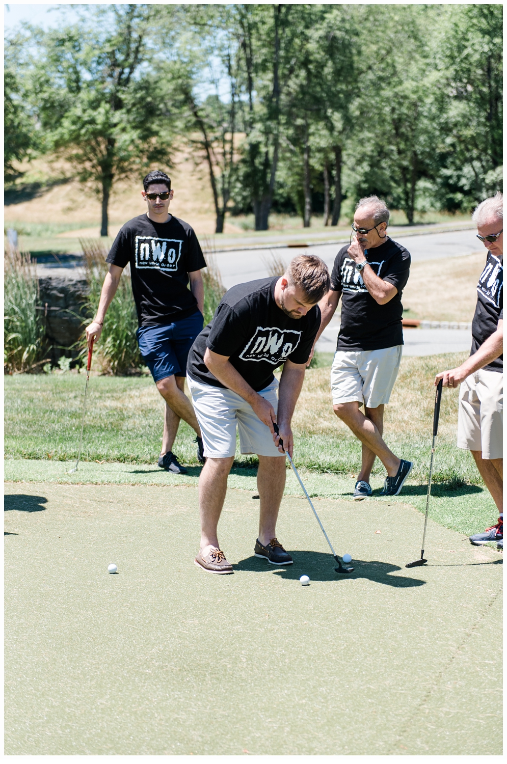 groom and groomsmen playing mini golf