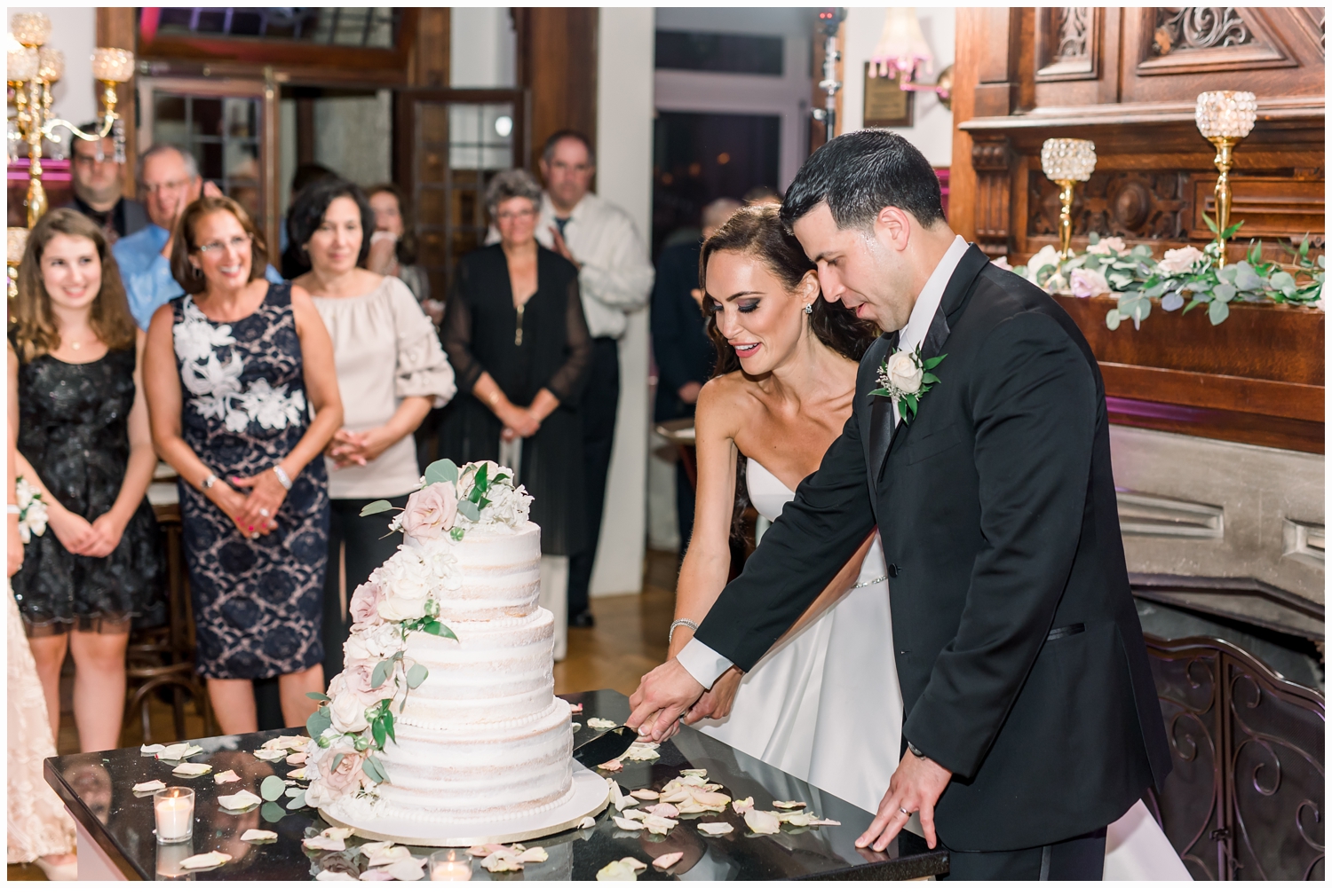 bride and groom cutting wedding cake