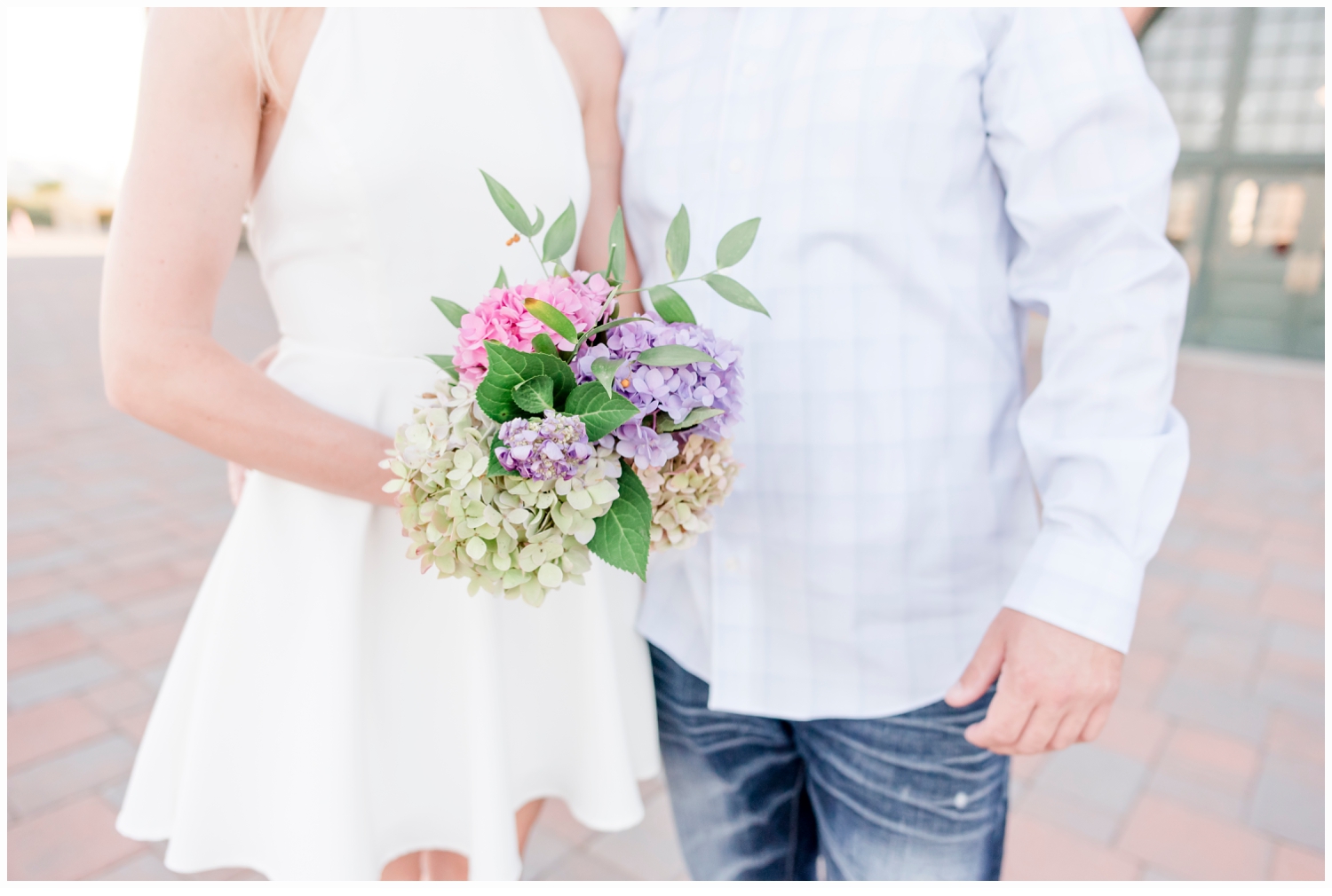 engaged couple holding flowers