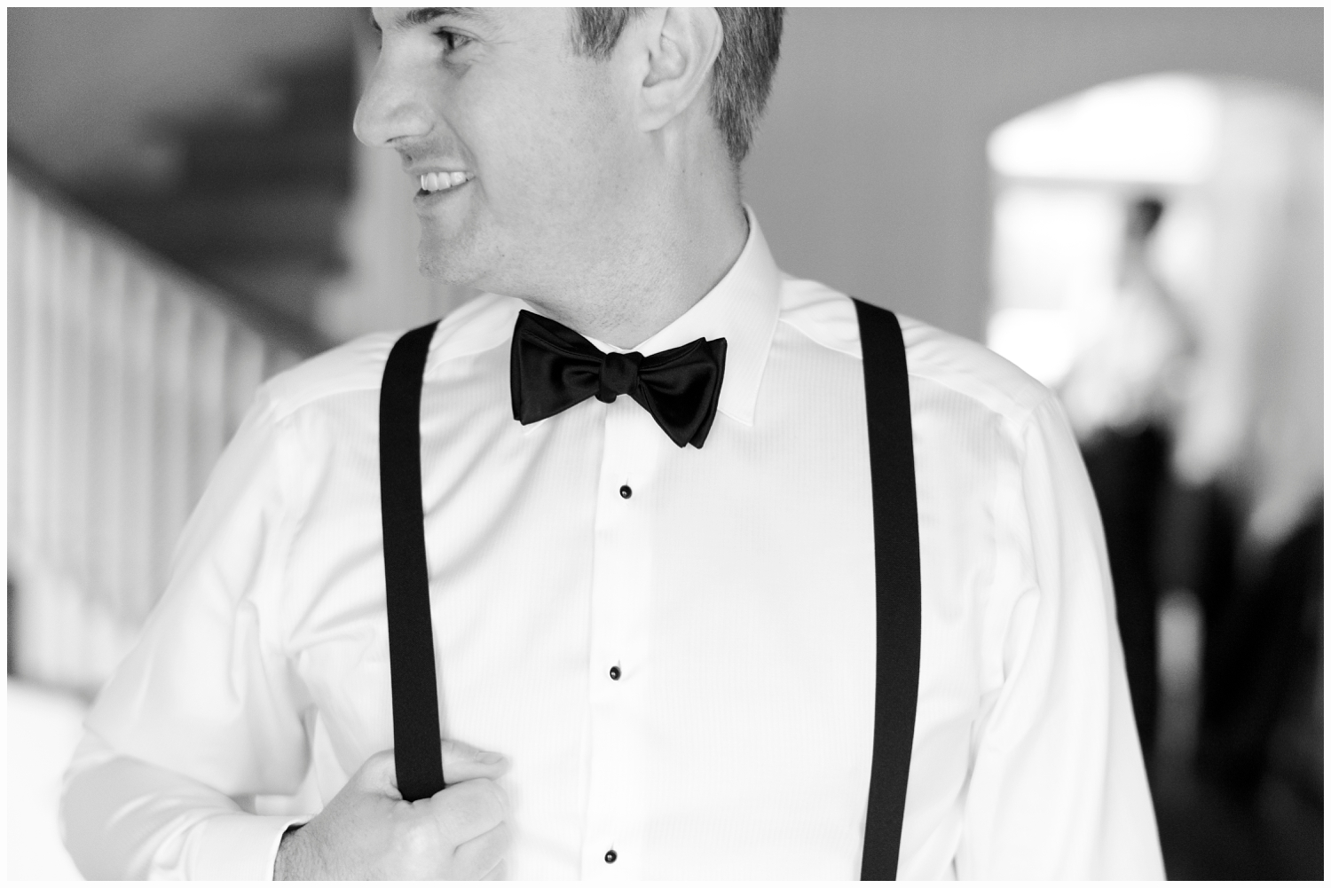 groom wearing a black tux