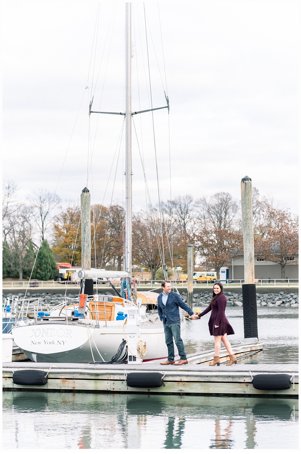 couple holding hands on marina dock