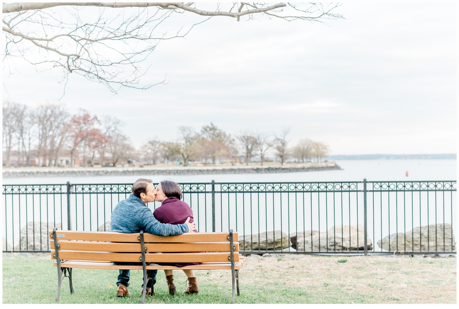 engaged couple sitting on a park bench