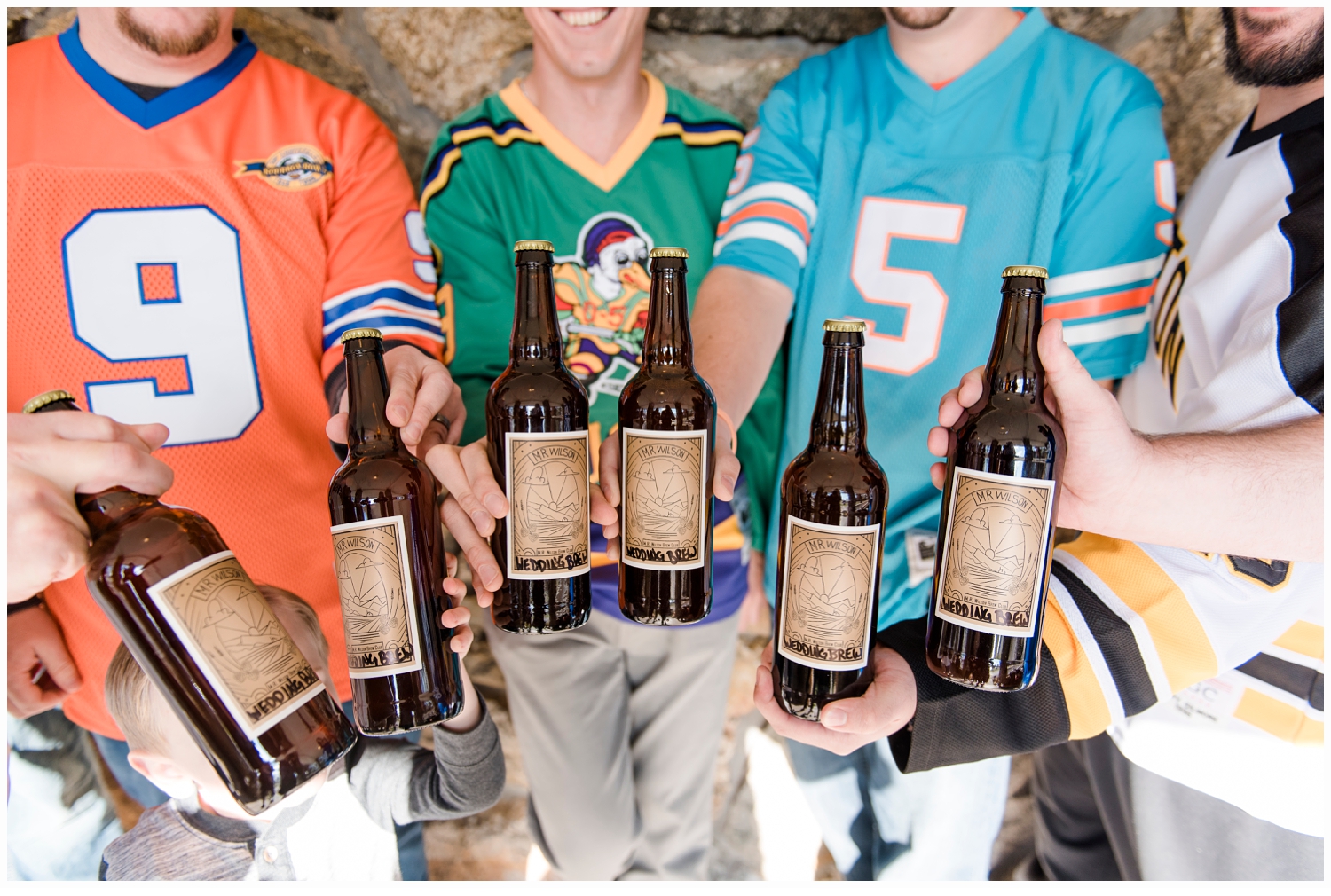 groom and groomsmen cheering with beers