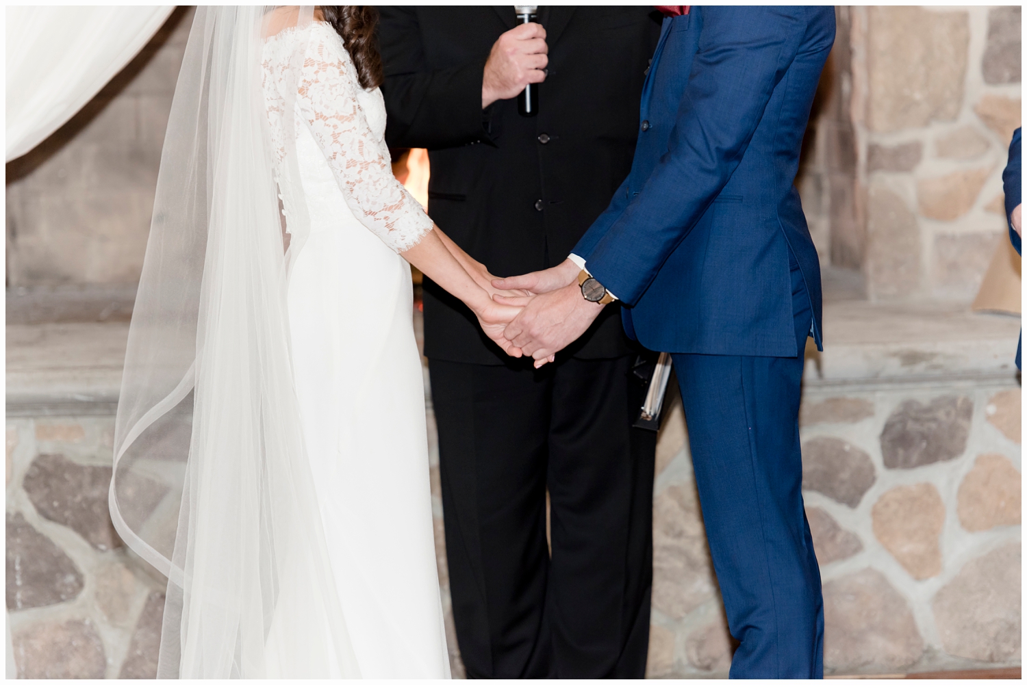 bride and groom holding hands saying vows at ceremony