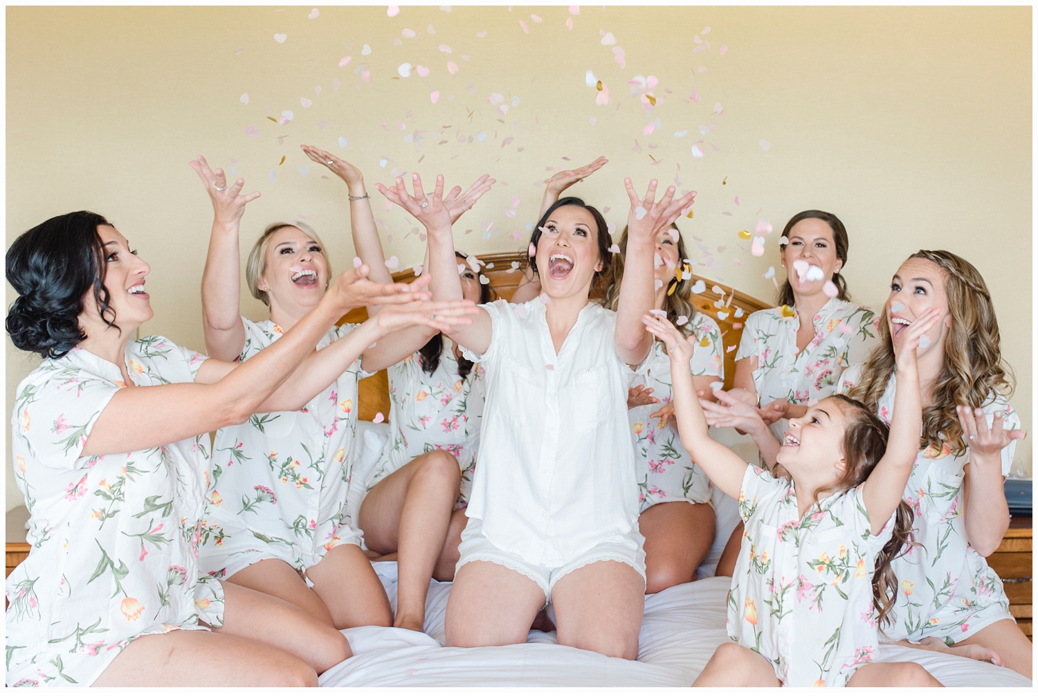 bridesmaids throwing confetti in the air