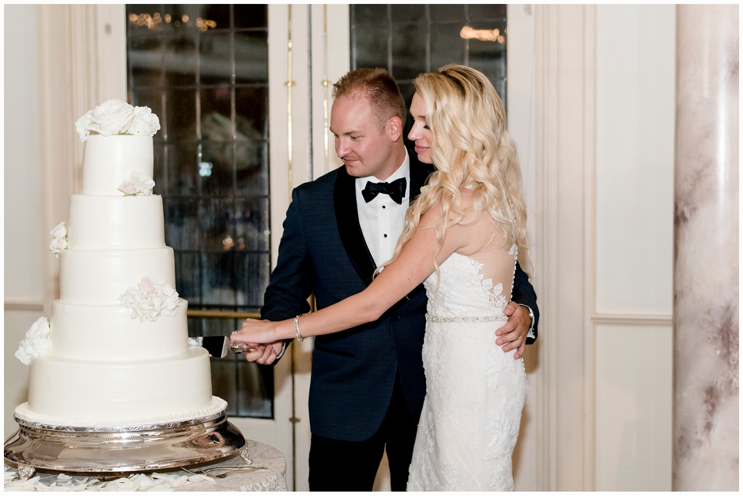 bride and groom cutting wedding cake