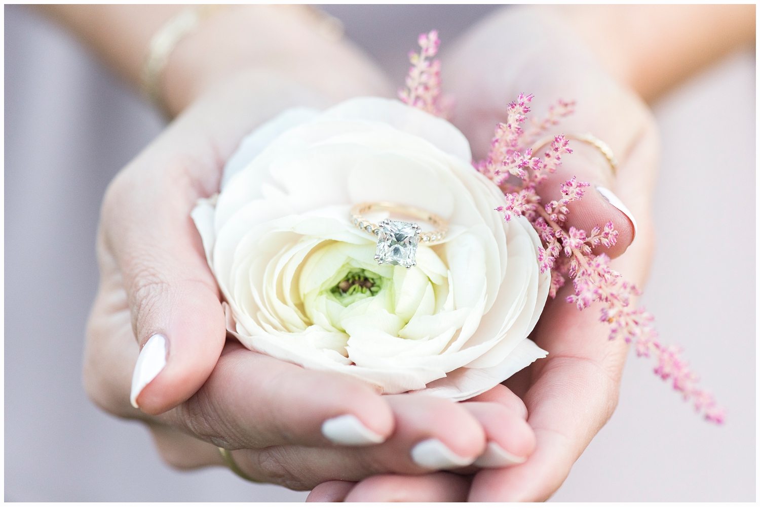 engagement ring shot in pretty white flower
