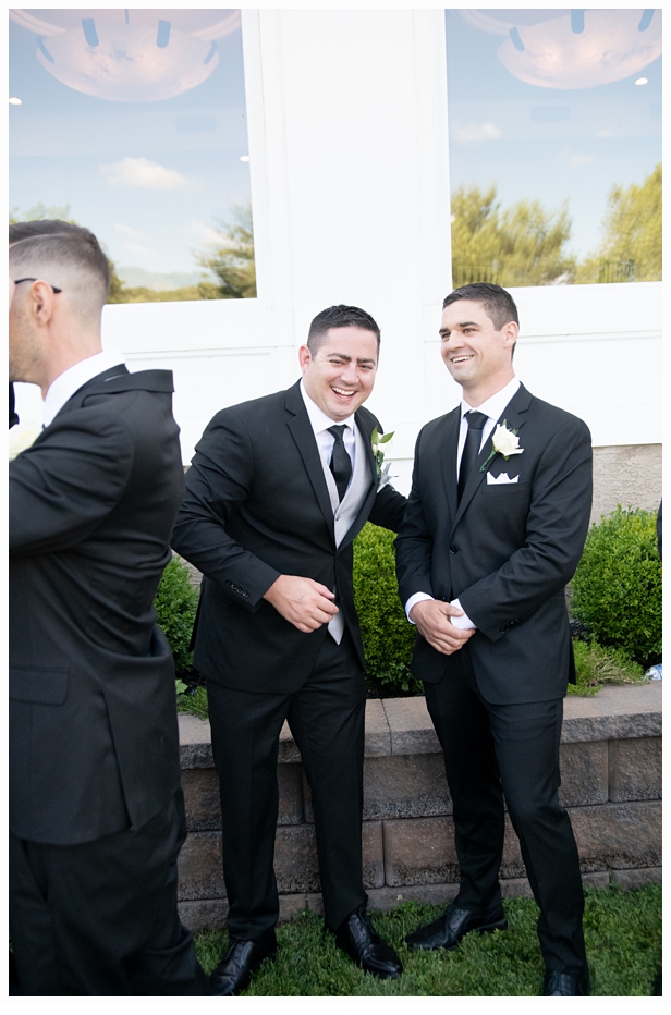 groom laughing with his groomsmen