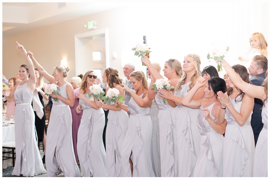 bridal party cheering for the bride and groom