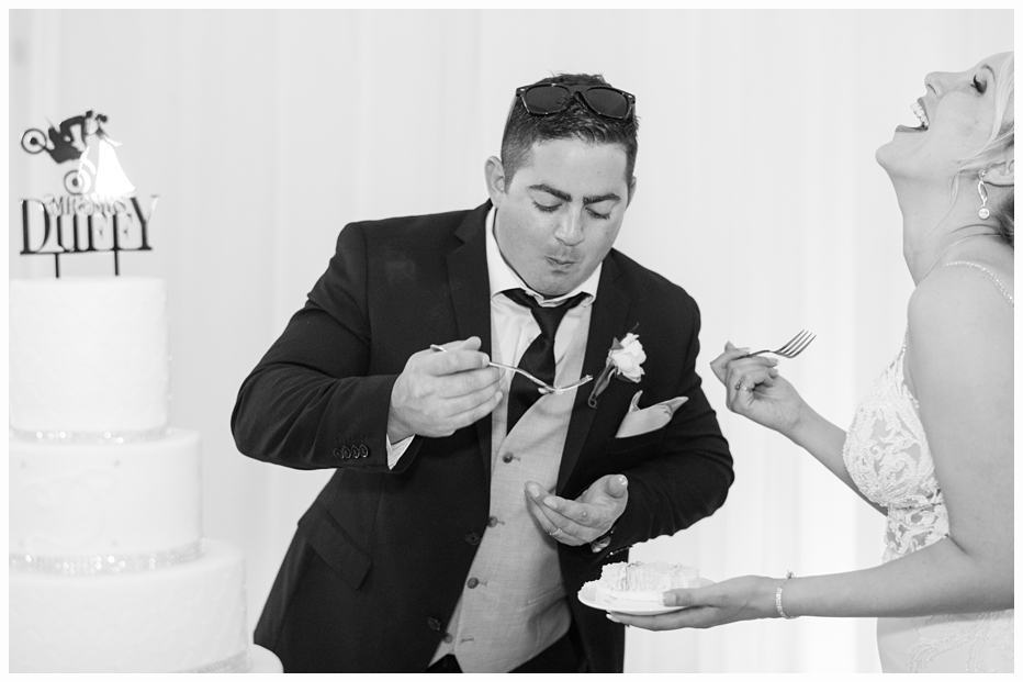 groom feeding bride wedding cake