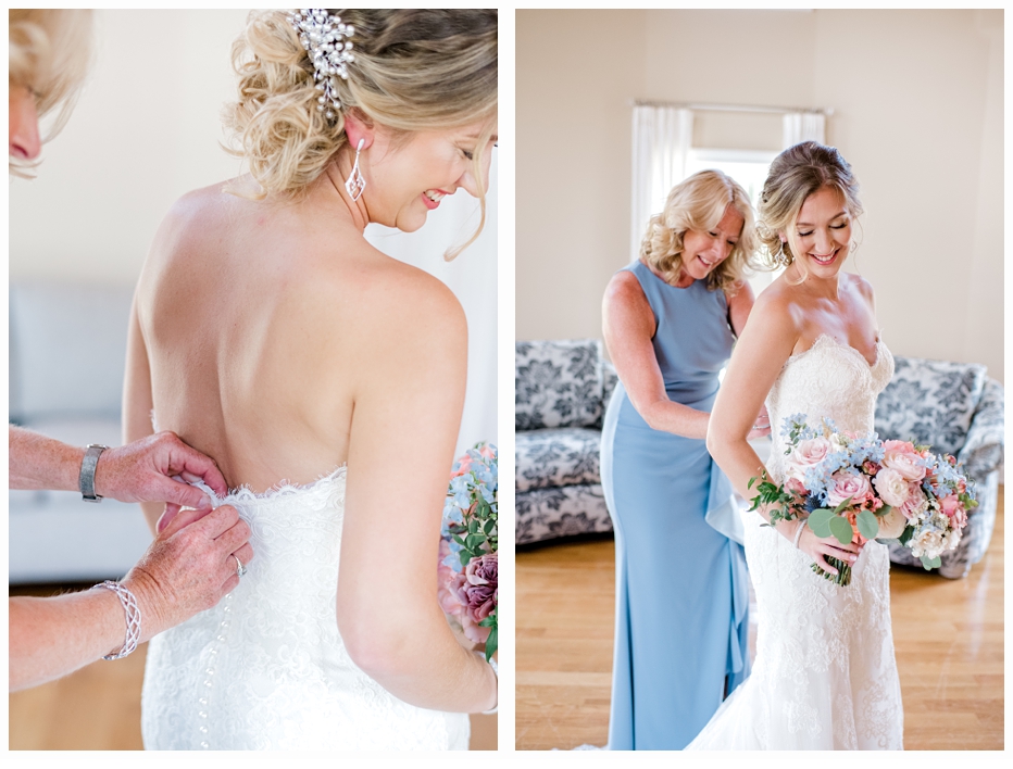 mother of the bride helping her put on her wedding dress