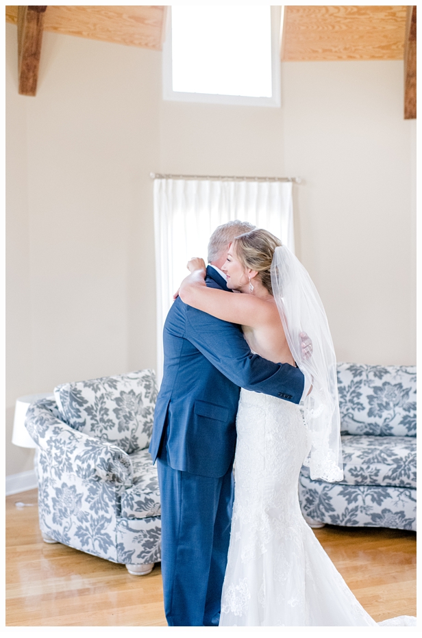 bride and father hugging on wedding day