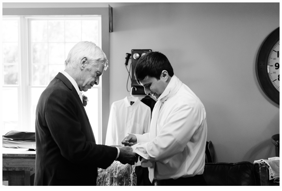 dad helping his son put on his cufflings on his wedding day