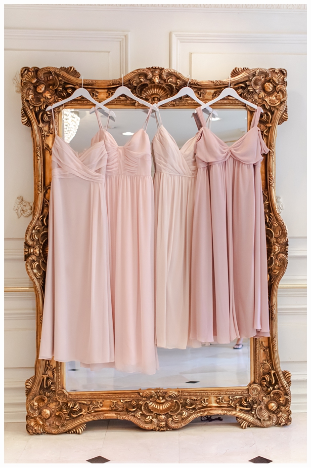 bridesmaids dresses hanging on gold mirror