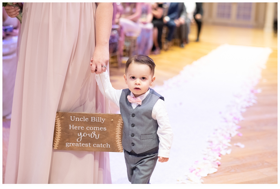 ringbearer carrying sign at wedding