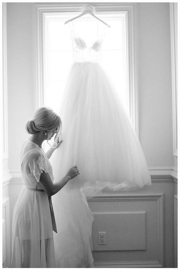 bride touching her wedding gown