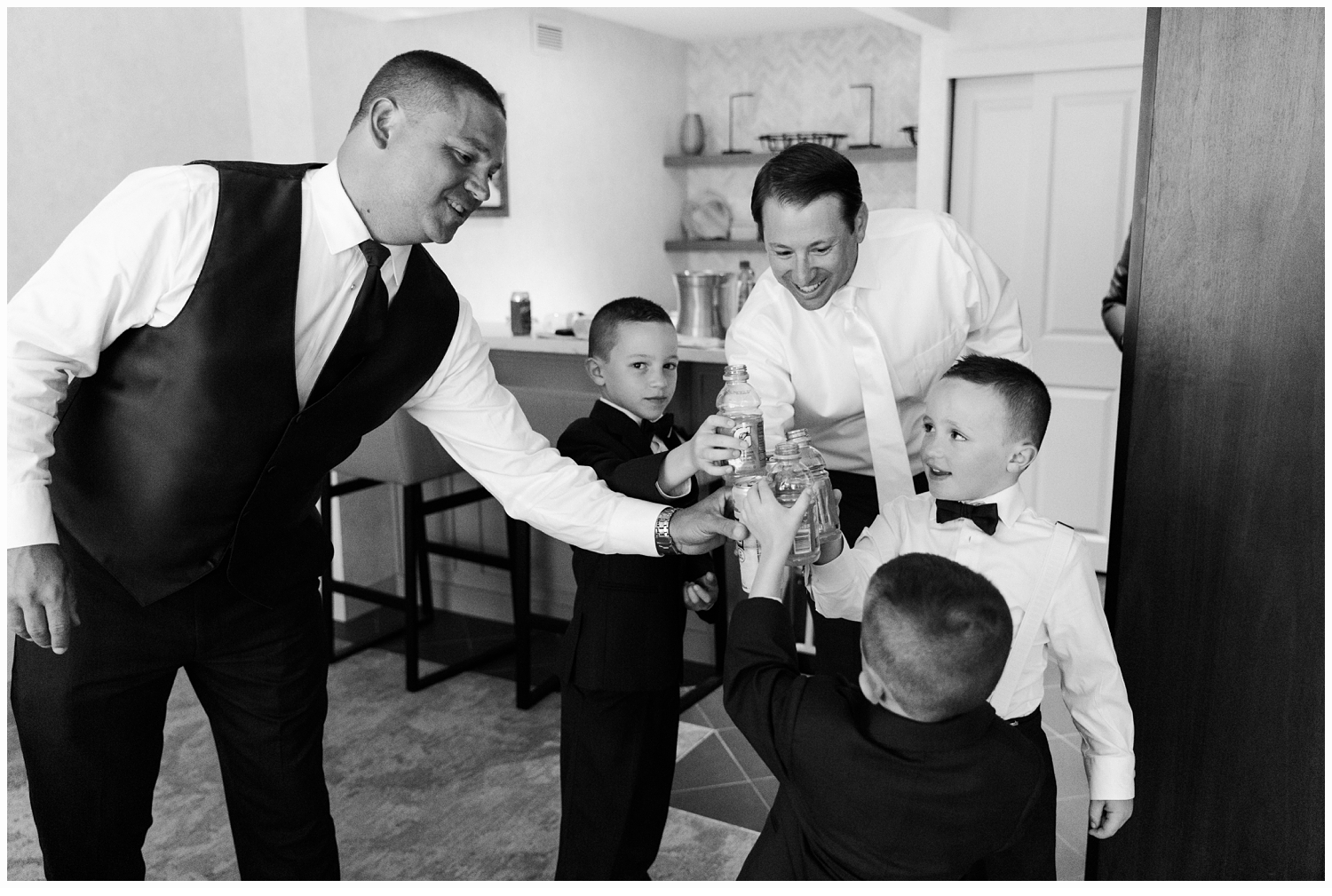 groom and ringbearers toasting on wedding day