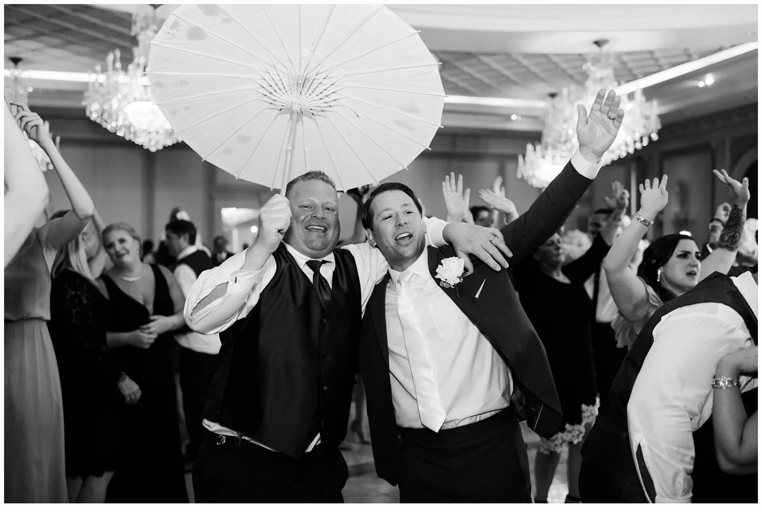groom dancing with best man at his wedding