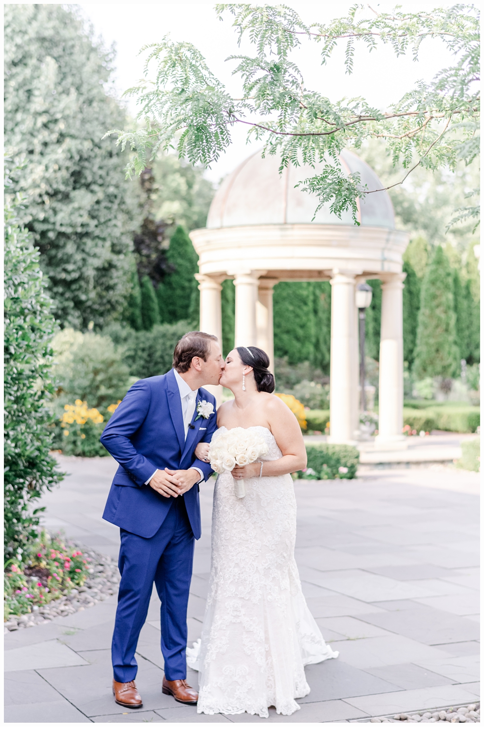 bride and groom portrait kissing and walking