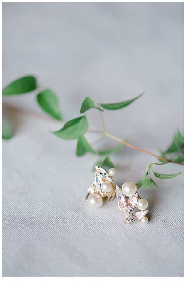 pearl earrings on a green vine