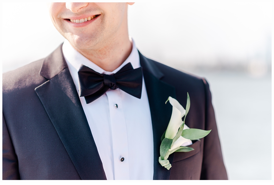 picture of groom smiling wearing a boutonniere