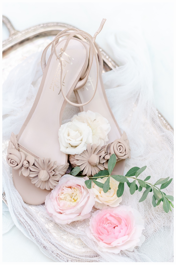 beige wedding shoes on a gold tray