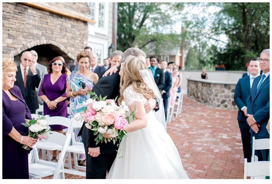 bride and dad kissing at the altar