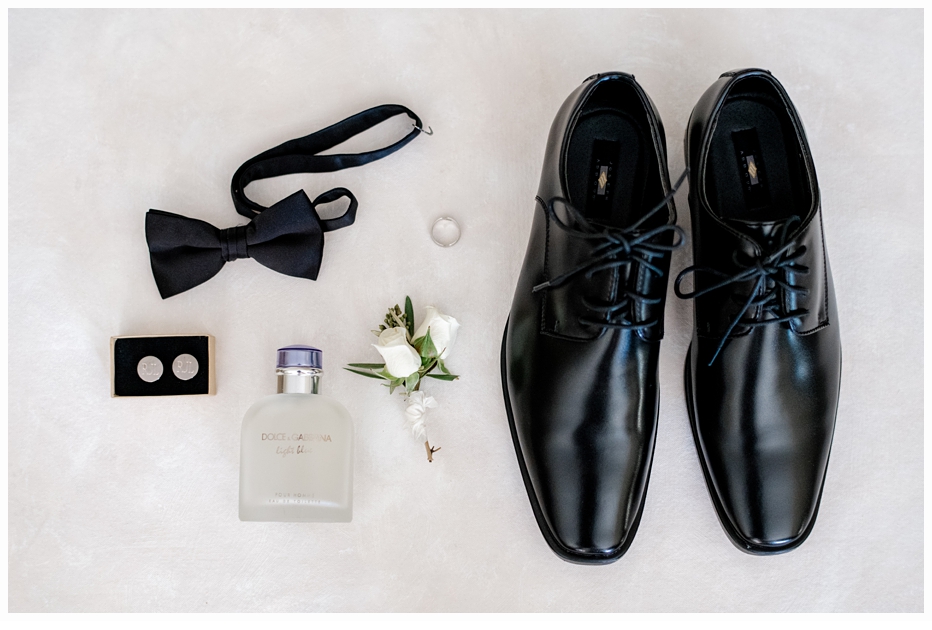 grooms tie, shoes and cufflings on a mat 