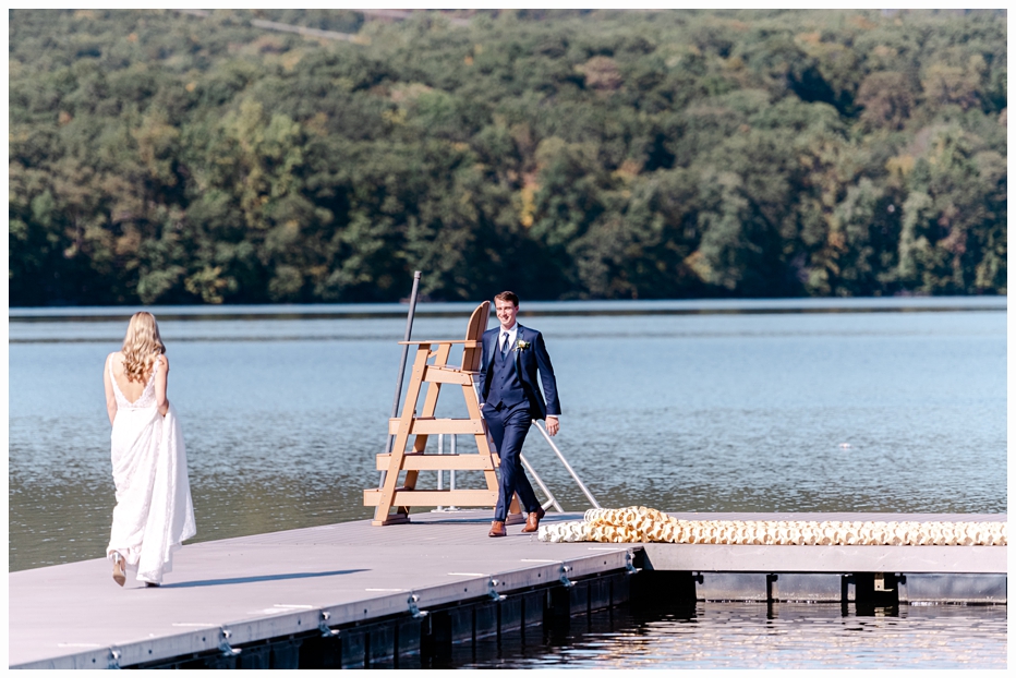 bride and groom on a dock having a first look