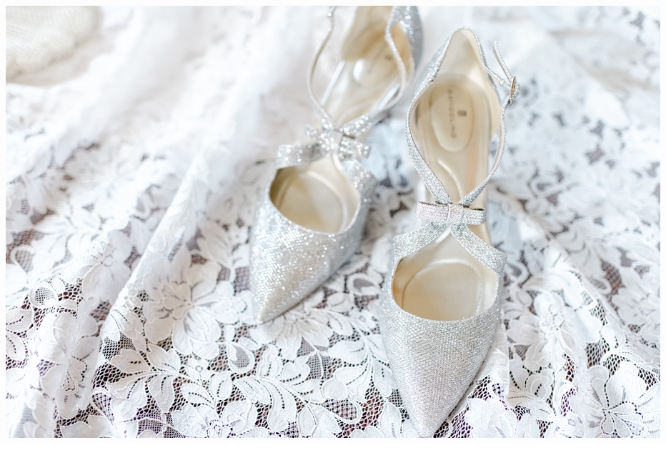 silver bridal shoes on the wedding gown