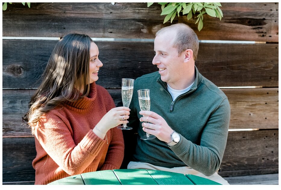engaged couple toasting with wine