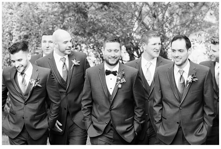 groom and groomsmen walking and laughing