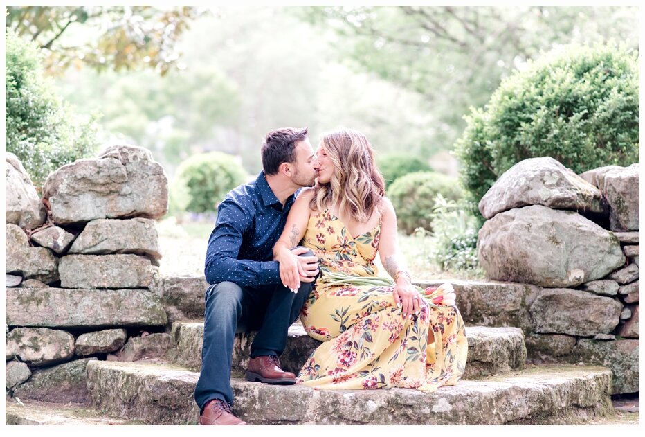 engaged couple kissing on a pretty stone staircase